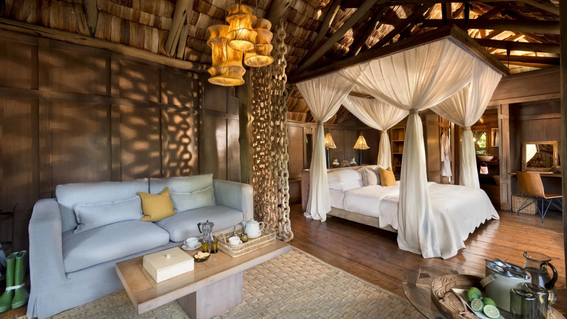 Treehouse suite with sitting area and canopy bed at Lake Manyara Tree Lodge